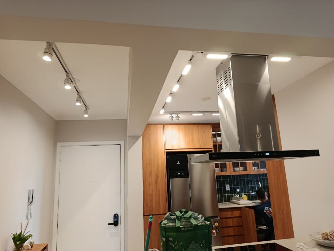 Trilho de spots iluminando a cozinha